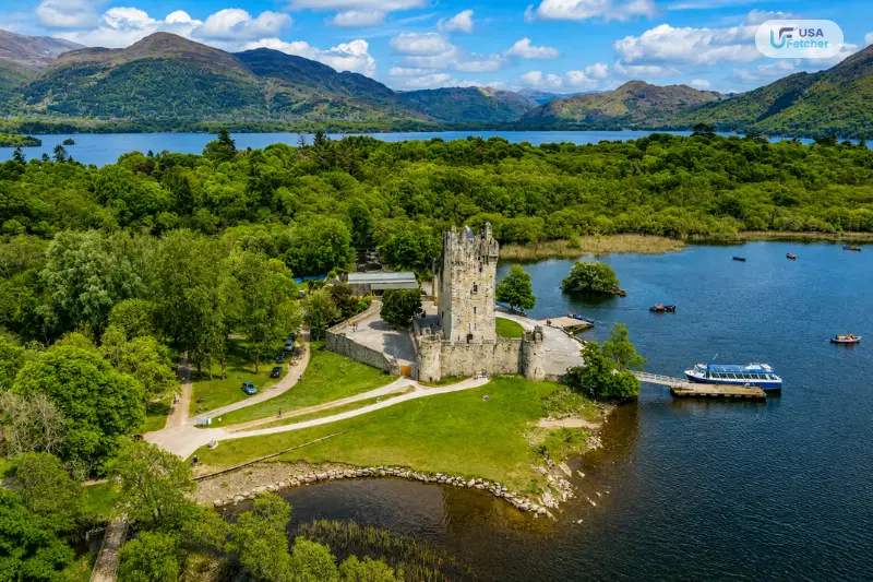 Aerial view of Killarney National Park with Ross Castle, Lough Leane, forests, and surrounding mountains in Ireland