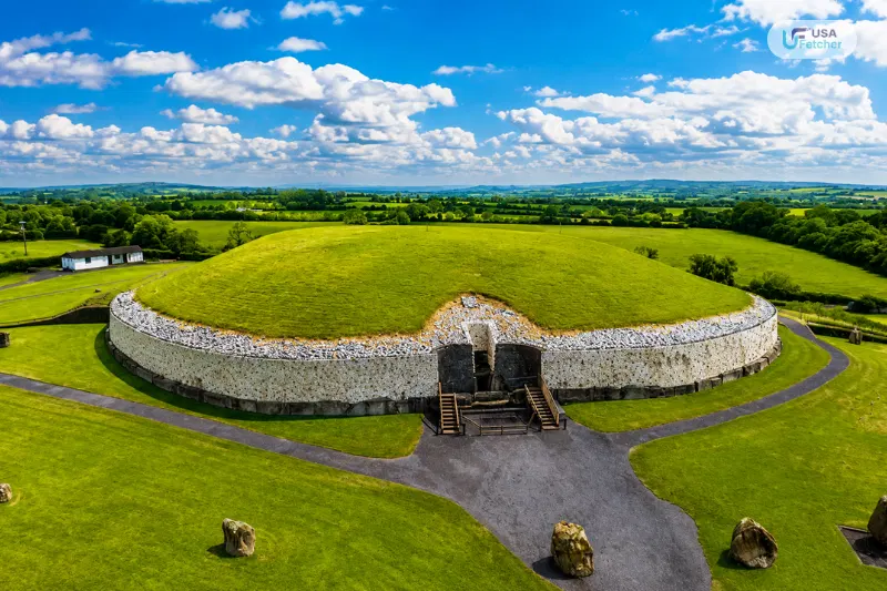 Aerial view of the ancient Newgrange passage tomb surrounded by lush countryside in Ireland