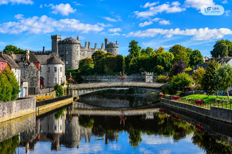 Kilkenny Castle overlooking the River Nore with a historic bridge and scenic city views in Ireland