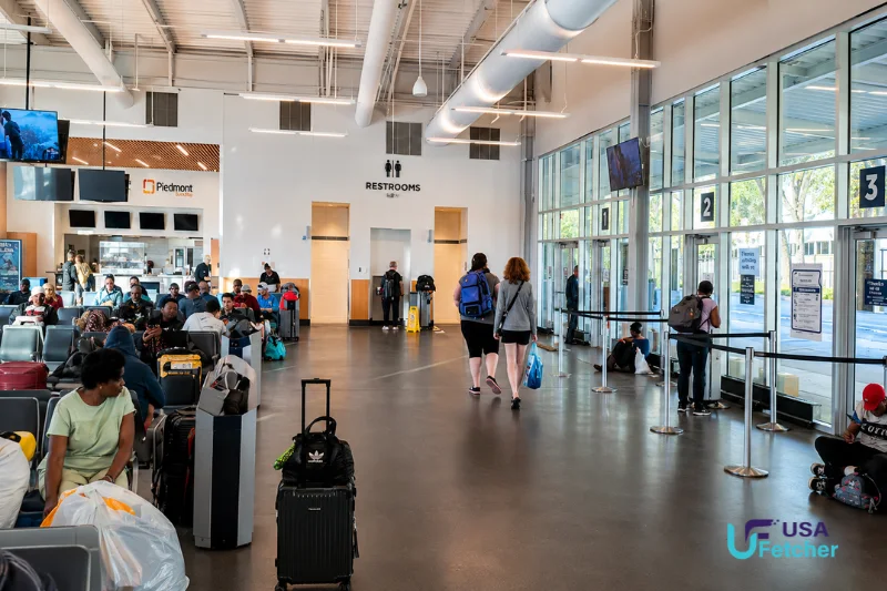 Passengers waiting inside the Atlanta Bus Station with seating, boarding gates, and traveler facilities